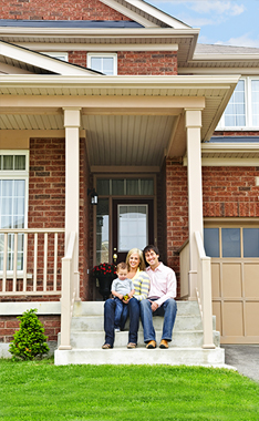 Family sitting on house steps