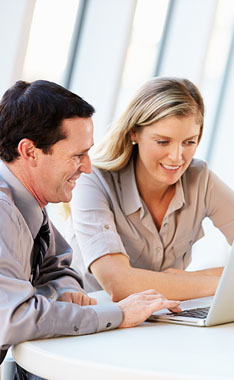 two employees looking at the computer